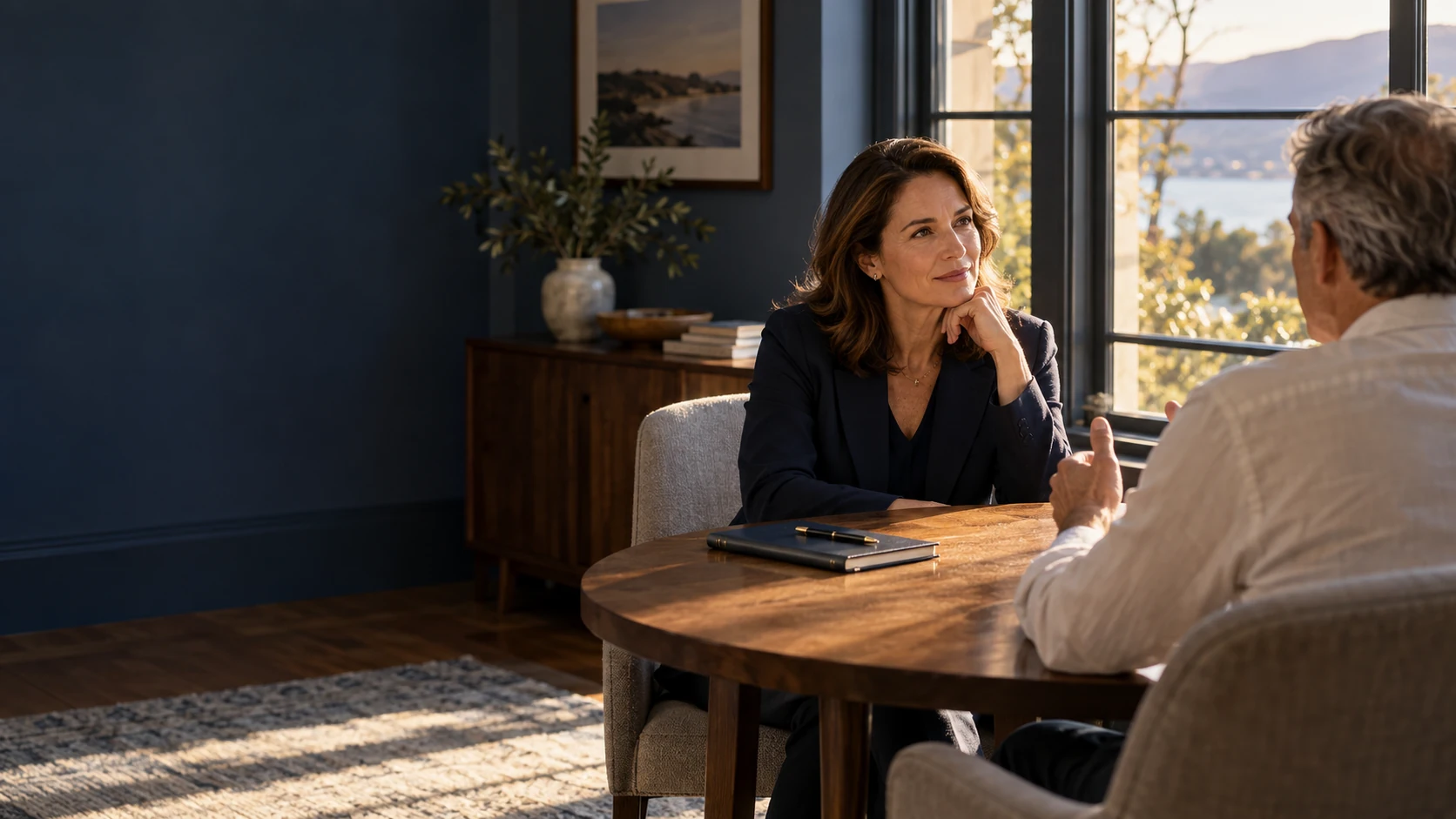 An illustrative conversation between two people at a table, with one listening attentively.